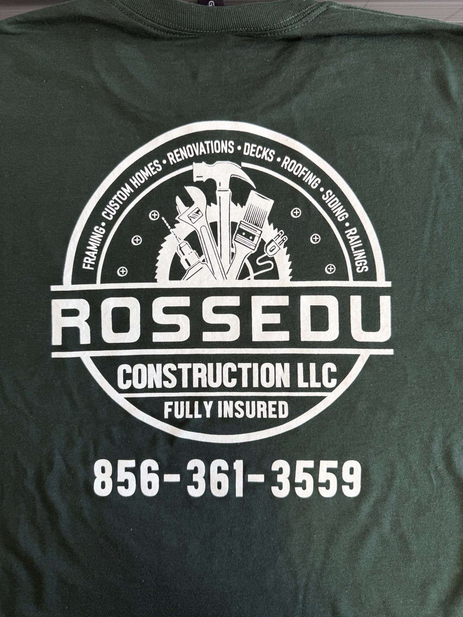 Rossedu Construction logo and phone number printed in white on a dark shirt